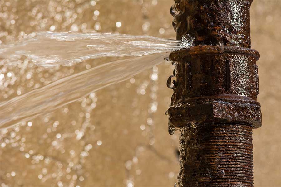 Damaged burst pipe leaking water